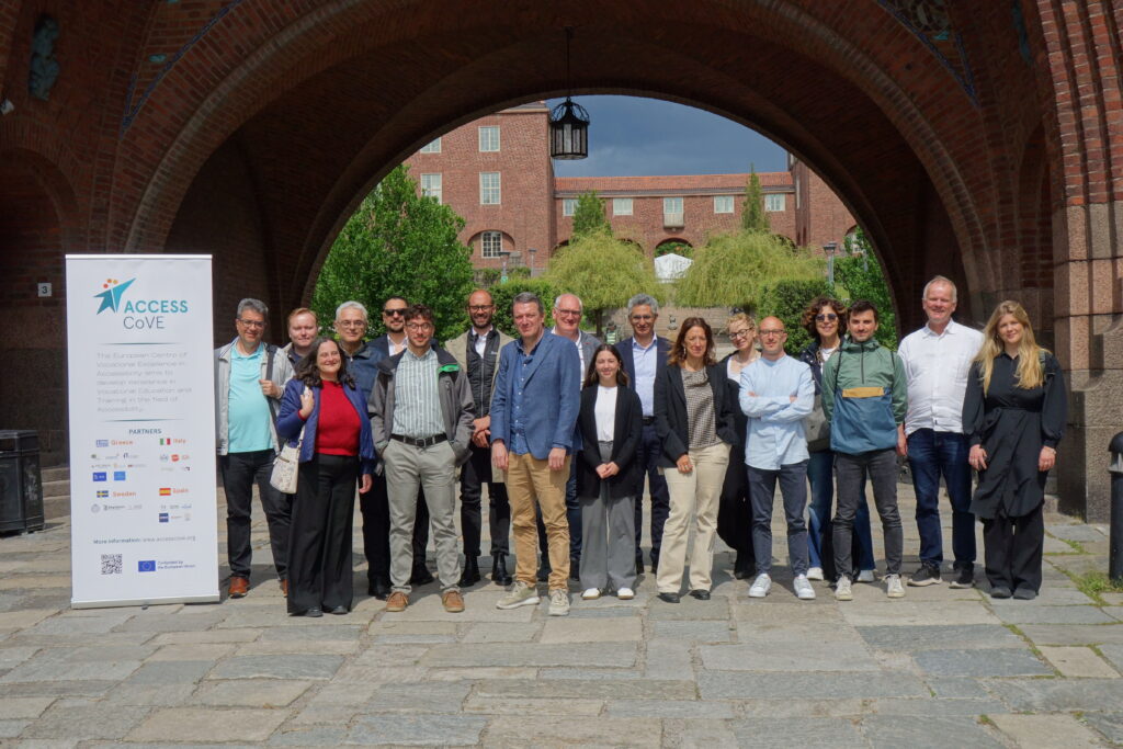 Project partners from all countries who were present in Stockholm is all gathered in front of KTH for the picture, standing beside a roller with the AccessCoVE logo. 